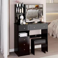 Compact vanity table features a left drawer, a cushioned stool, a large sliding mirror on the right side, and multiple storage compartments